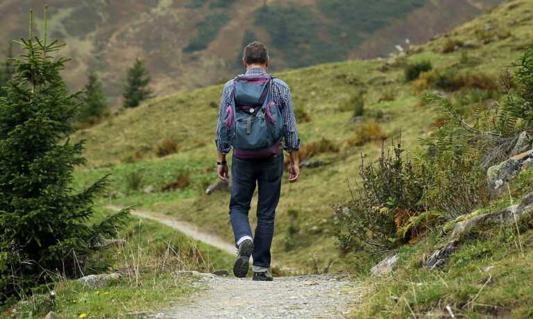 man hiking on trail